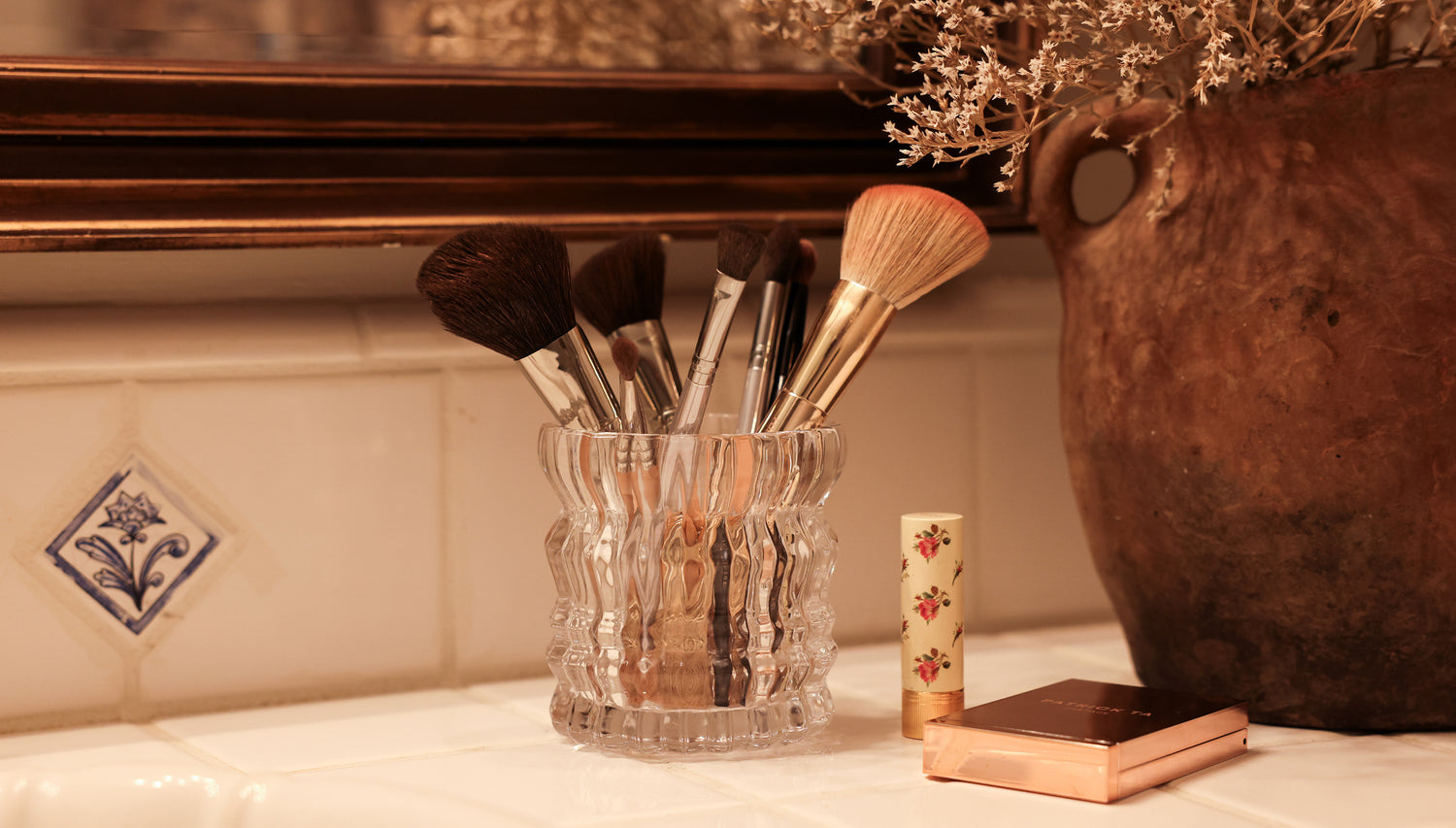 The Arlow candle is being repurposed as a glass that holds make up brushes.