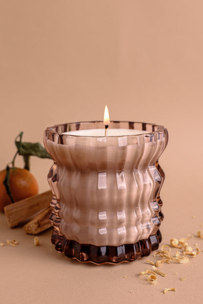 The Willow Non-Toxic Candle in Textured Glass Vessel is elegantly displayed alongside the fresh scent of neroli.