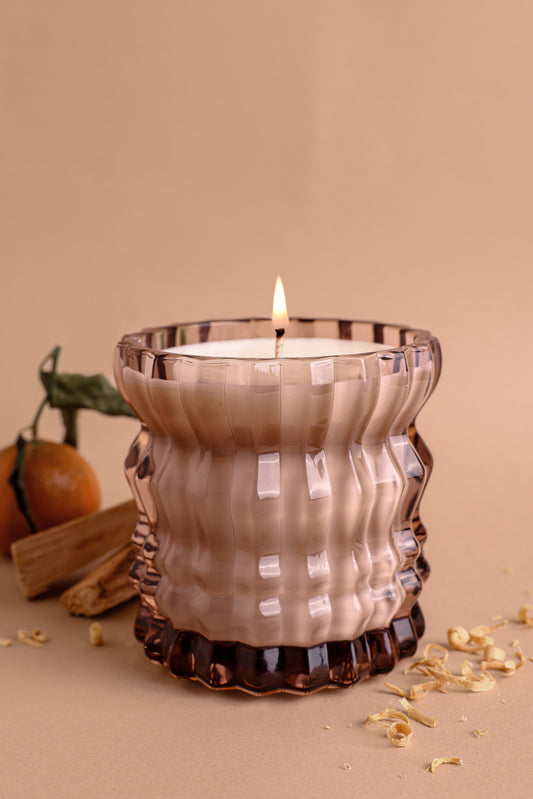 The Willow Non-Toxic Candle in Textured Glass Vessel is elegantly displayed alongside the fresh scent of neroli.